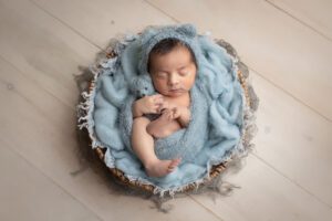 newborn photographer in rochester ny captures baby boy with teddy bear