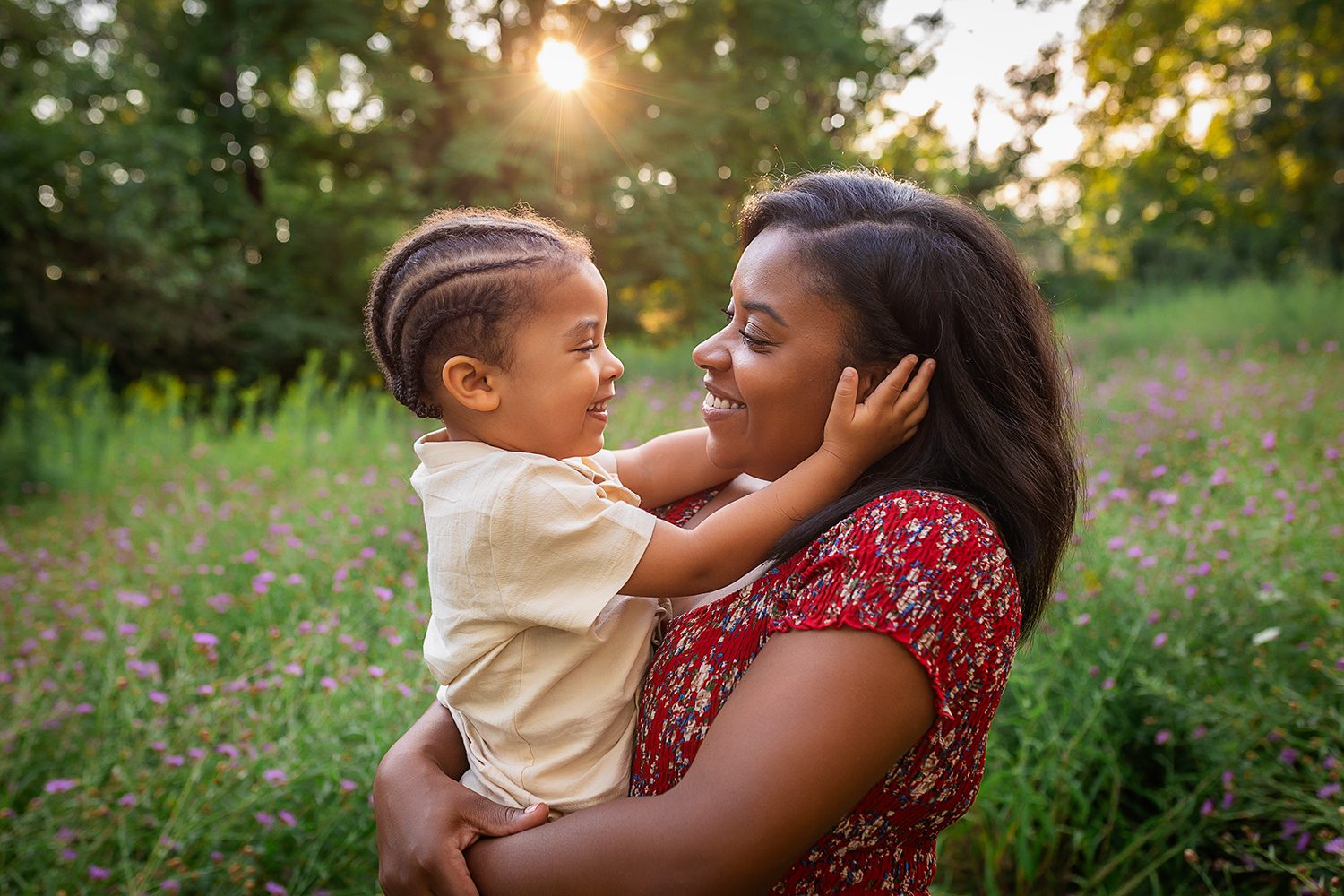 family photographer in rochester ny captures mom and son in the wildflowers at sunset