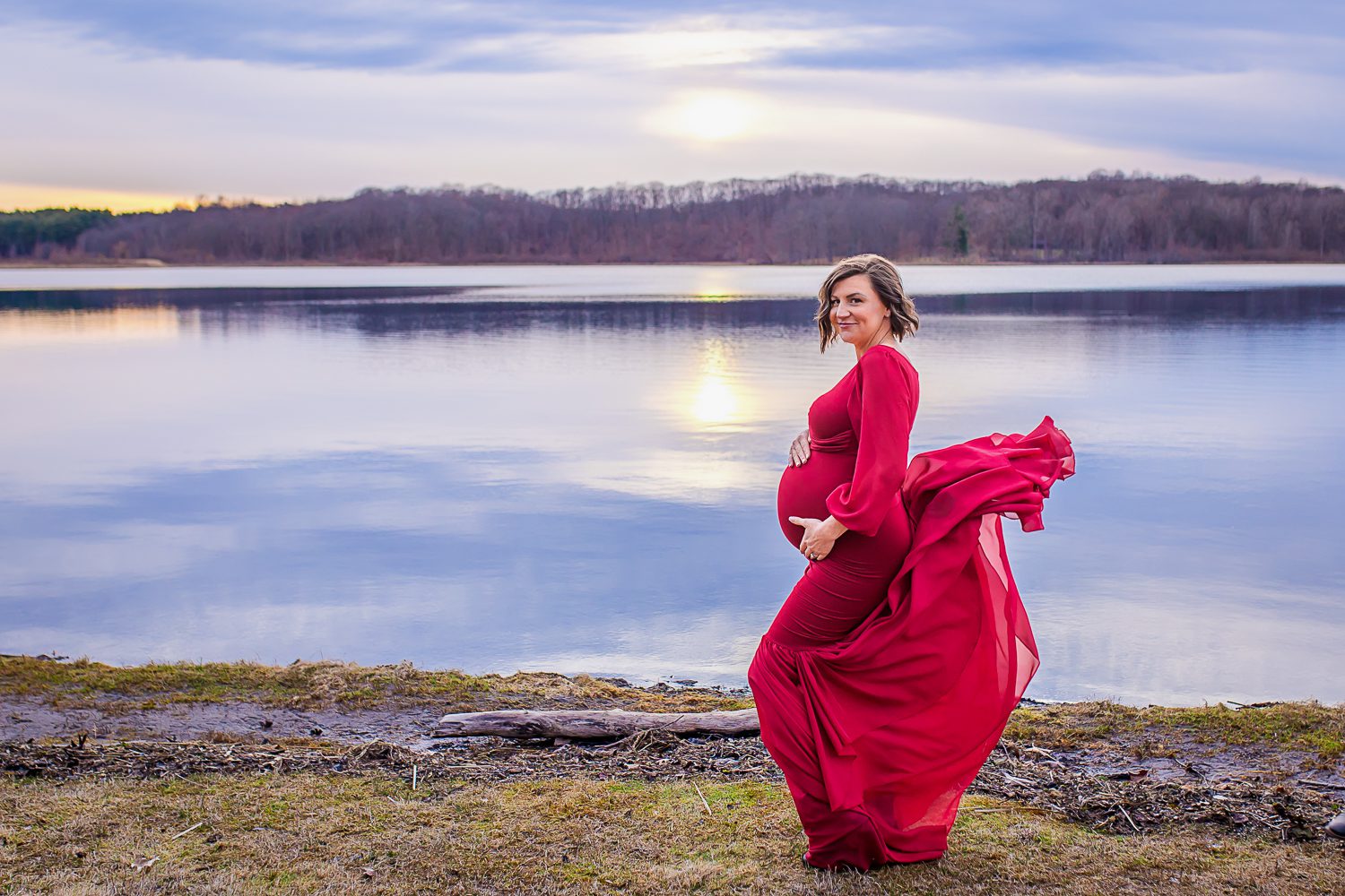 maternity photographer in rochester ny captures expectant mom with her dress blowing in the wind