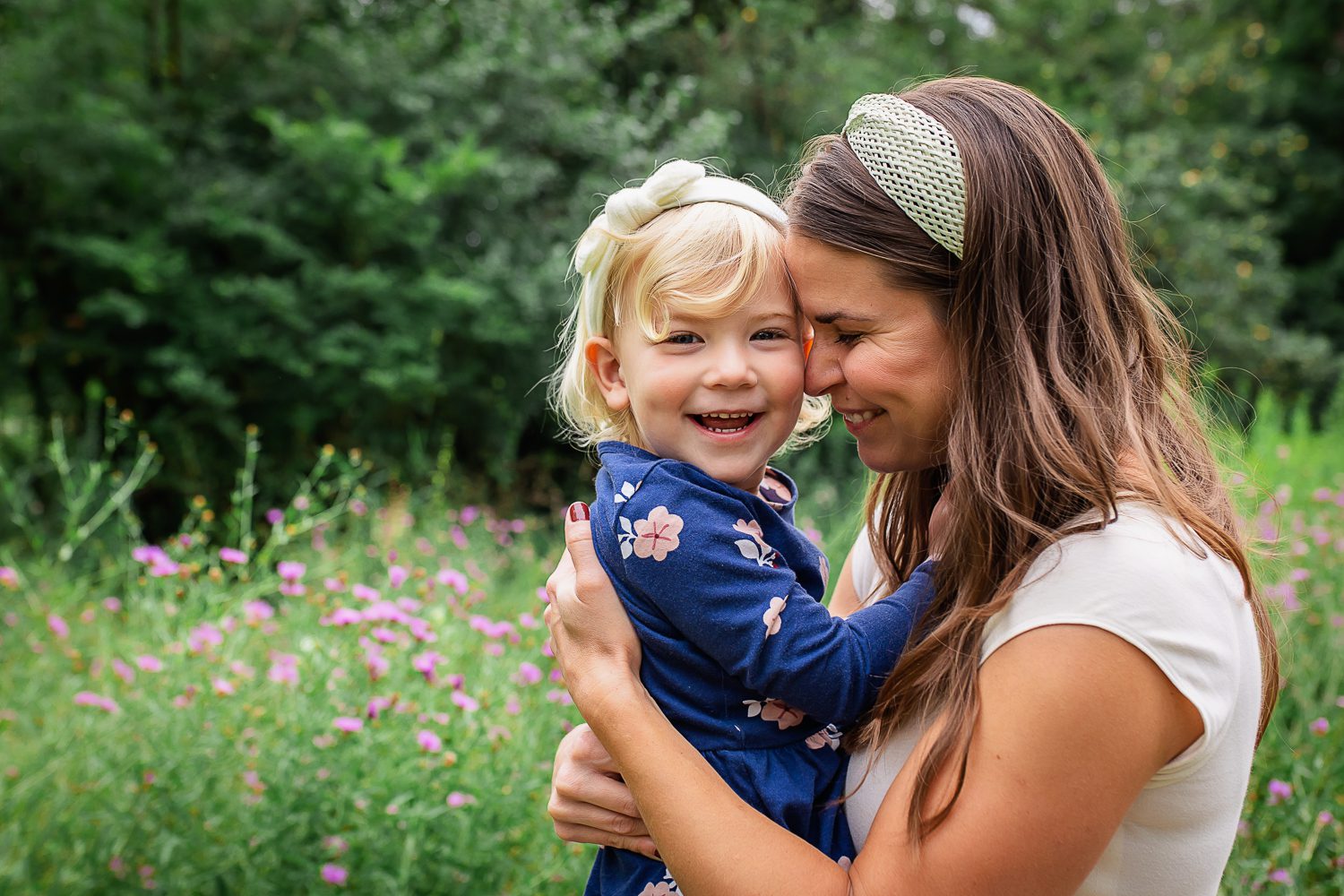 family photographer in rochester ny captures mom and daughter in a flower field