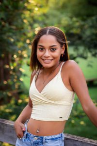 Family photographer in rochester ny captures senior portraits in a park at sunset