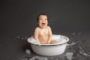 baby photographer in rochester ny captures first birthday cake smash