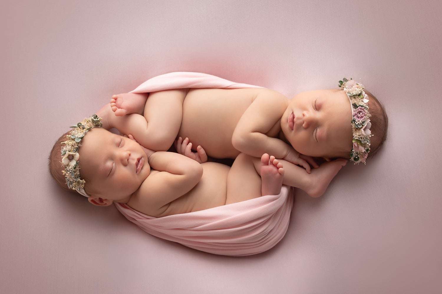newborn photographer in rochester ny captures twin newborn girls sleeping together
