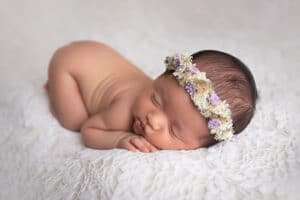 newborn photographer in rochester ny captures newborn baby girl sleeping with flower crown on
