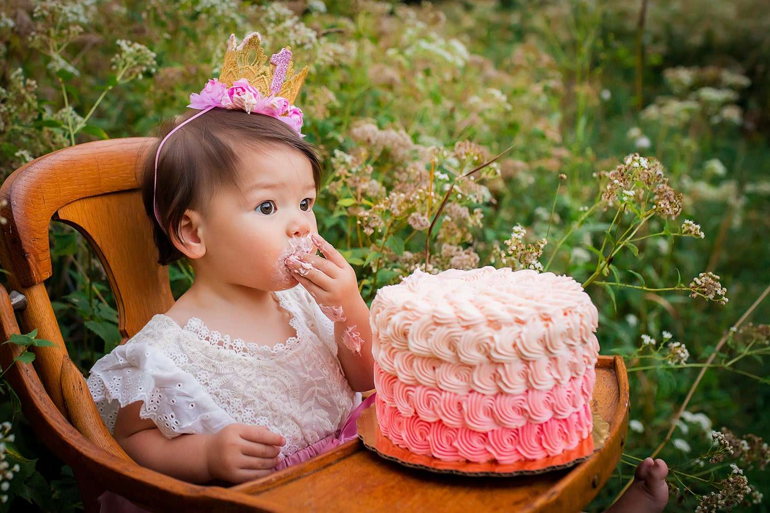 baby photographer in rochester ny captures baby girl celebrating first birthday with a cake smash