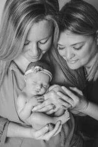 newborn photographer in rochester ny captures two moms with their newborn baby girl