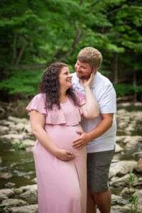 maternity photographer in rochester ny captures expectant parents laughing together