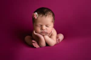 newborn photographer in rochester ny captures newborn baby girl sleeping in froggy pose