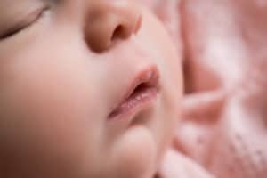 newborn photographer in rochester ny captures newborn baby girl sleeping
