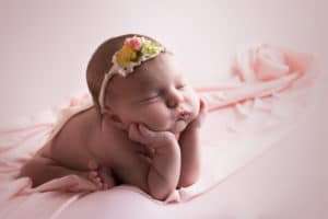 newborn photographer in rochester ny captures newborn baby girl sleeping in froggy pose