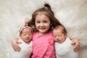 newborn photographer in rochester ny captures newborn twins sleeping with their big sister