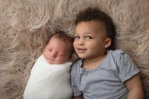 newborn photographer in rochester ny captures newborn baby boy with his big brother