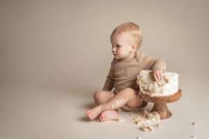 newborn photographer in rochester ny captures cake smash for baby's first birthday