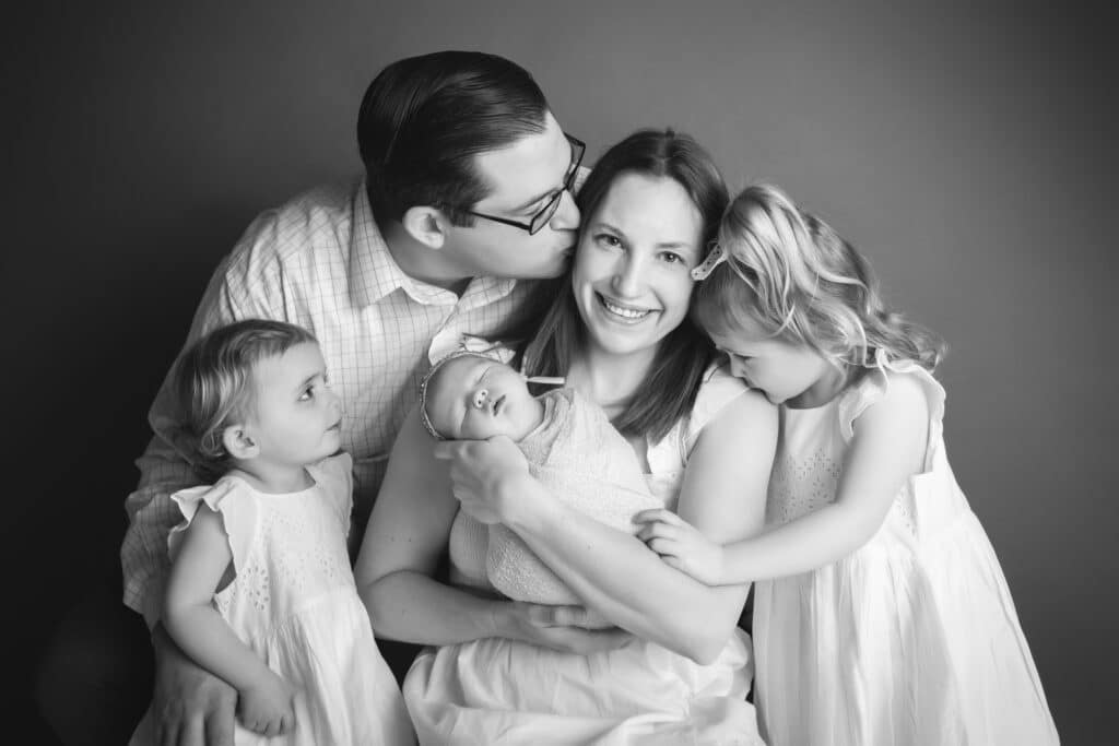newborn photographer in rochester ny captures sleeping newborn baby with her family