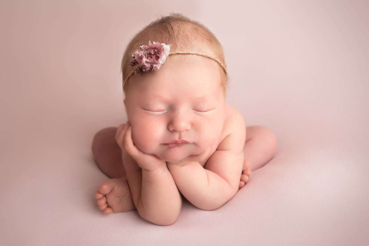 newborn photographer in rochester ny captures sleeping newborn baby in froggy pose
