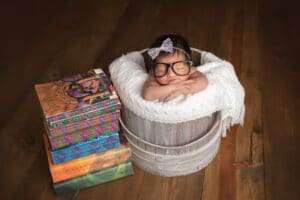 newborn photographer in rochester ny captures baby girl sleeping with Harry Potter books