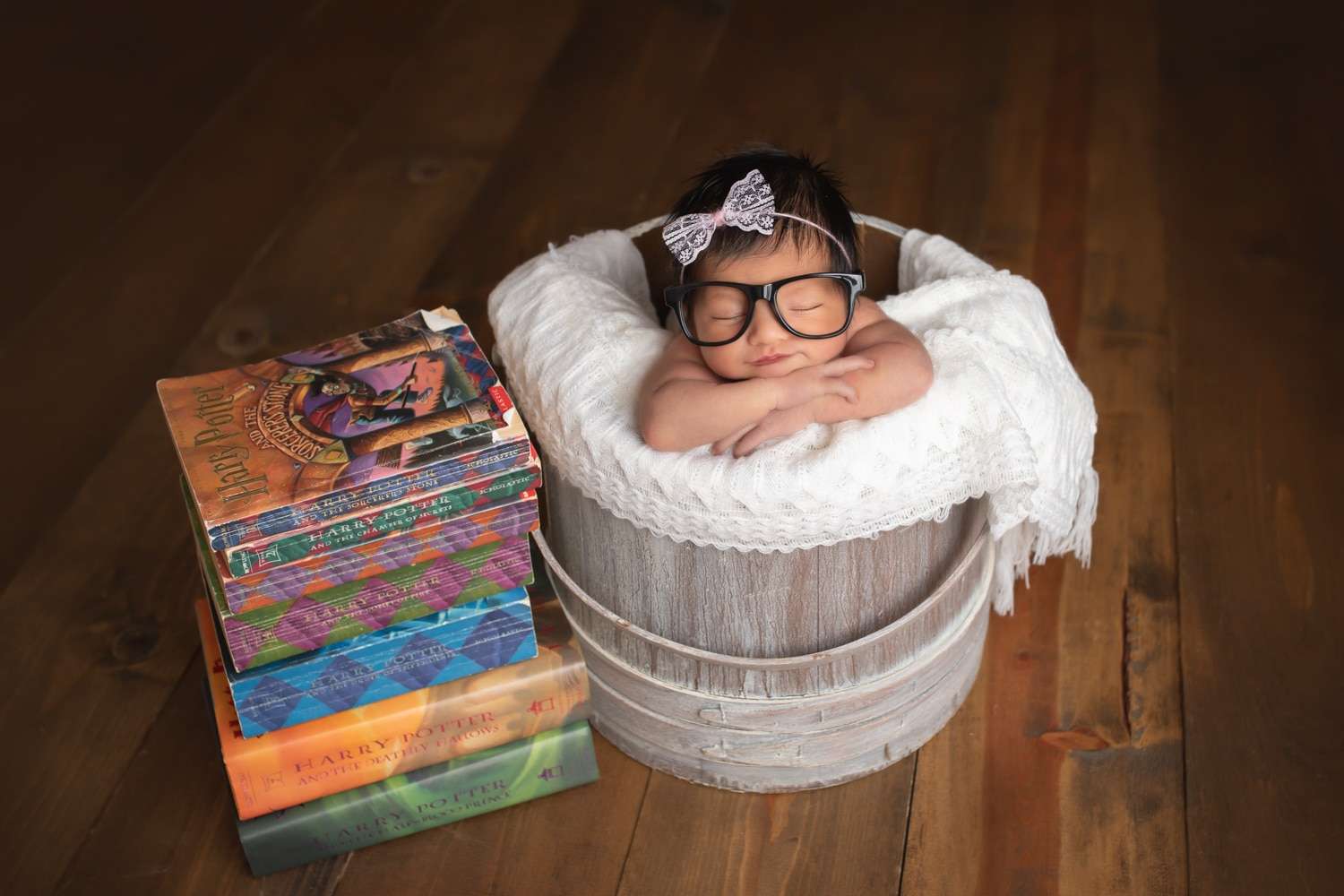 newborn photographer in rochester ny captures baby girl sleeping with Harry Potter books