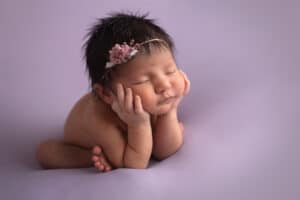 newborn photographer in rochester ny captures baby girl sleeping in froggy pose