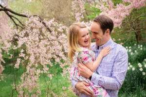 family photographer in rochester ny captures family portraits in the Spring blooms at Highland Park