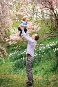 family photographer in rochester ny captures family portraits in the Spring blooms at Highland Park