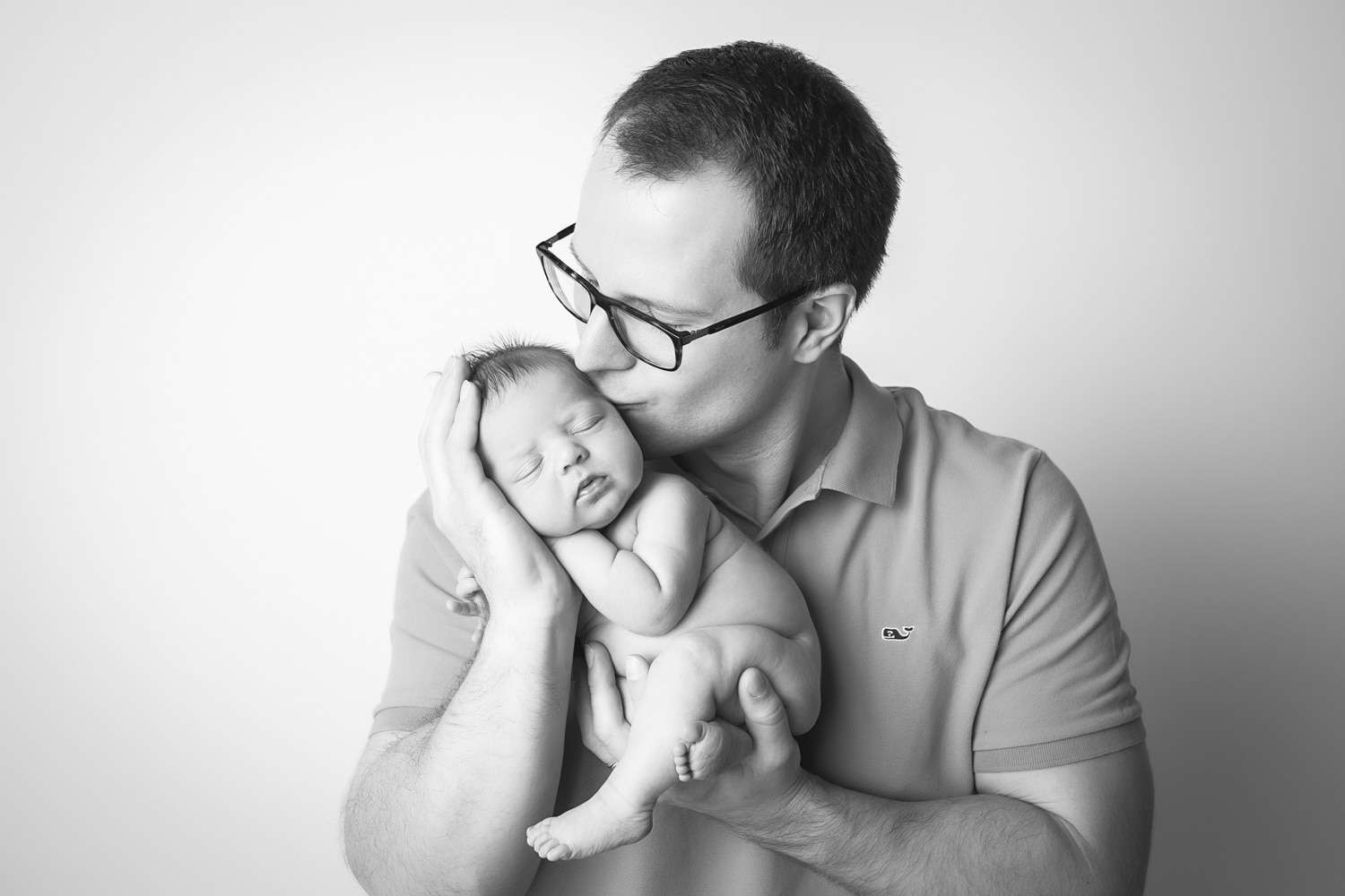 newborn photographer in rochester ny captures newborn baby girl sleeping in her dad's arms