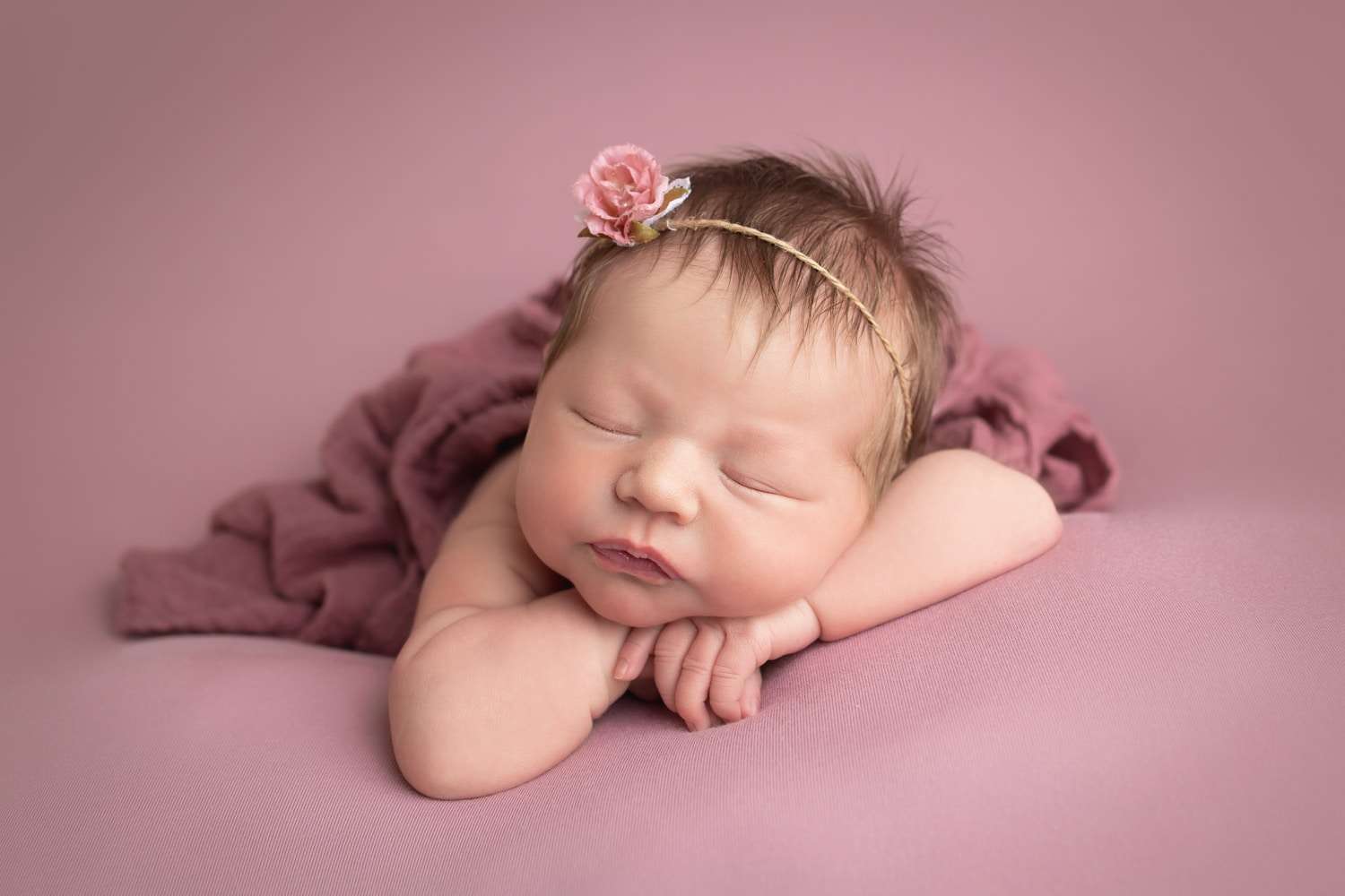 newborn photographer in rochester ny captures newborn baby girl sleeping chin on hands