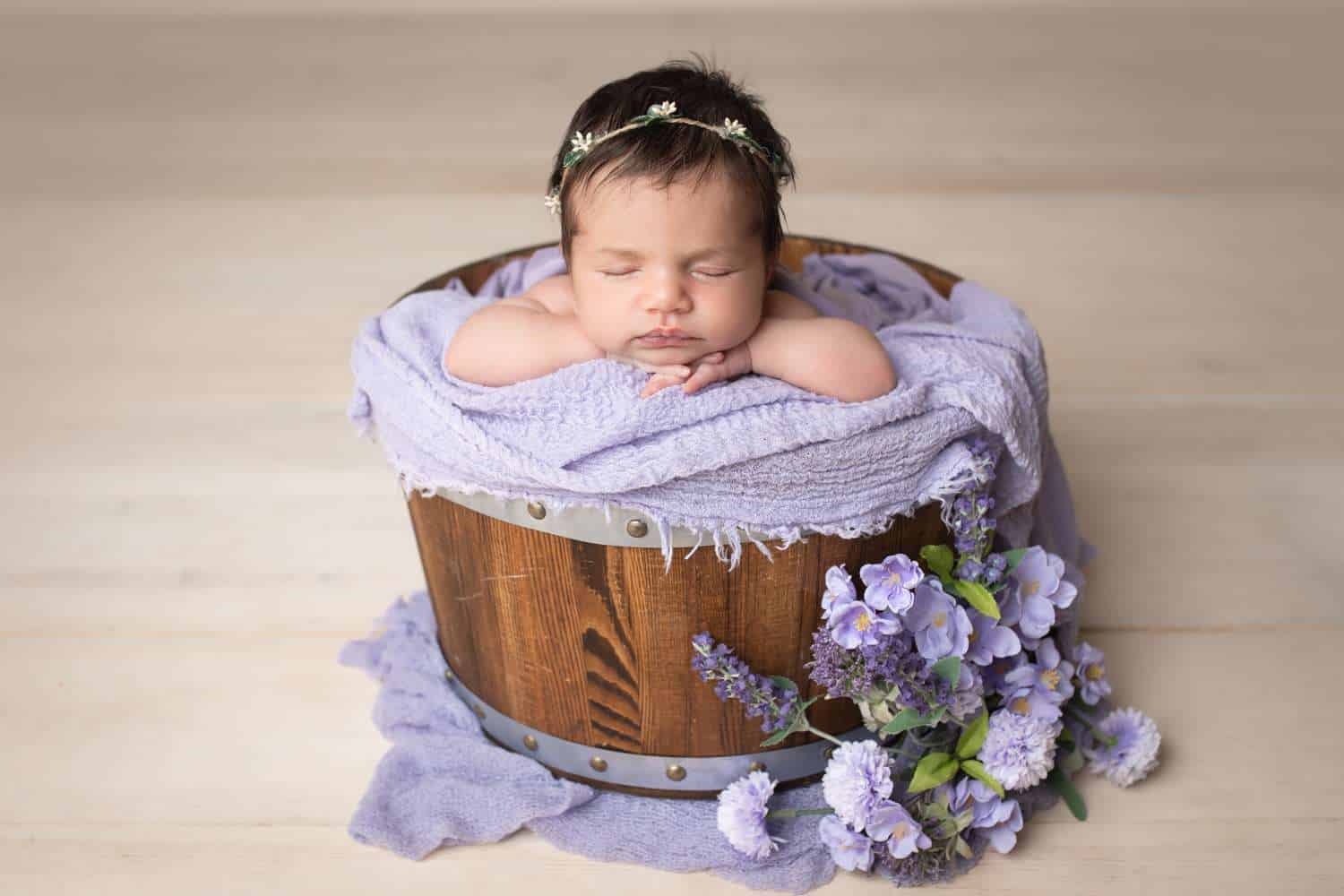 newborn photographer in rochester ny captures newborn baby girl in a bucket