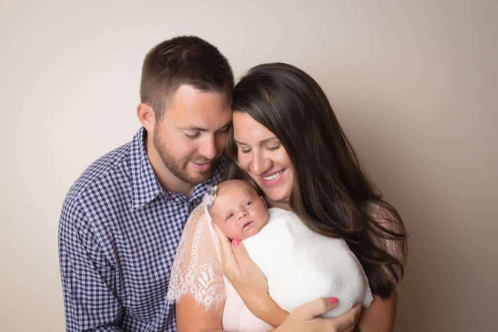newborn photographer in rochester ny captures newborn baby girl with her parents