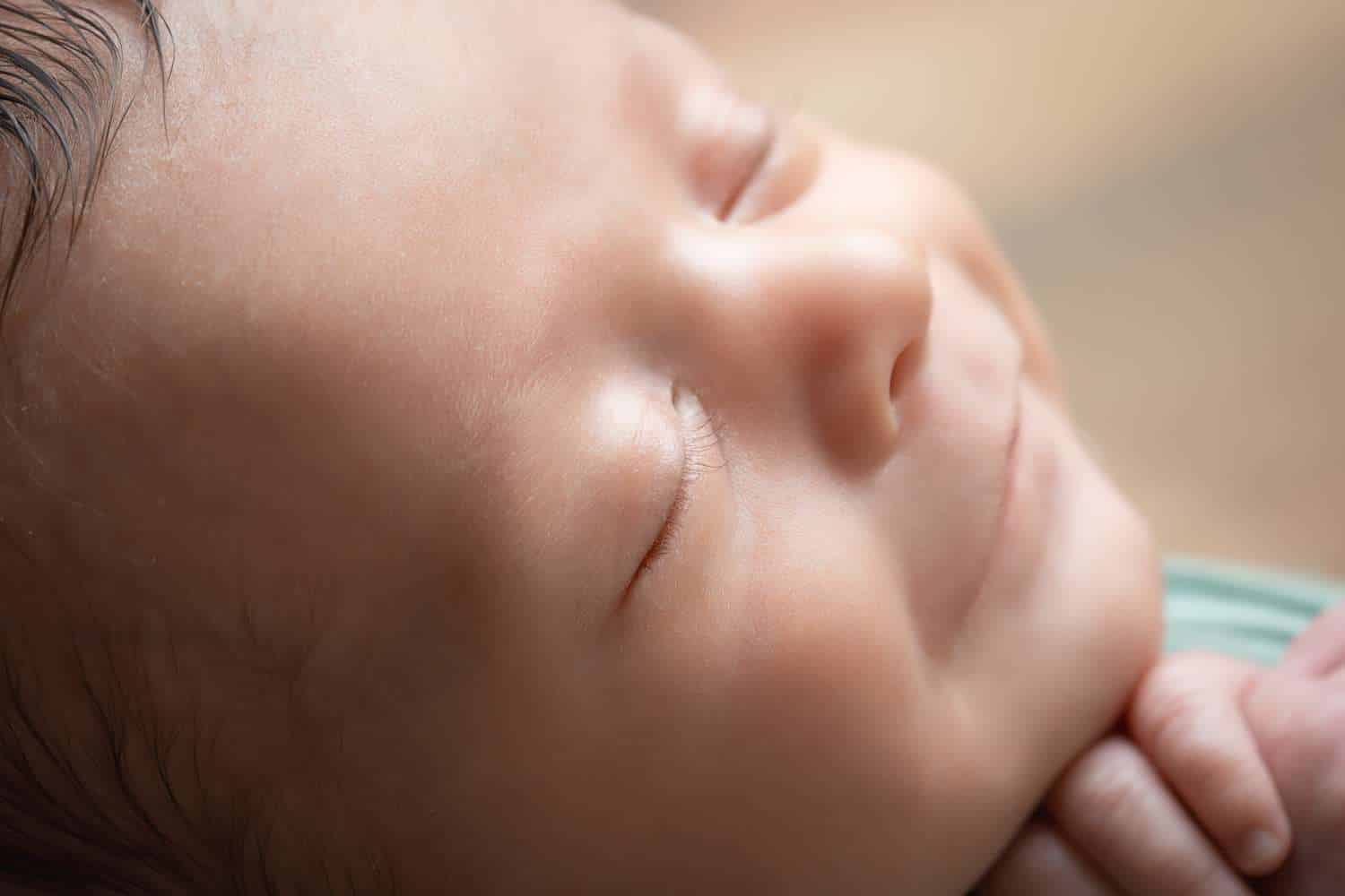 newborn photographer in rochester ny captures macros image of newborn baby boy's eyelashes and smile 