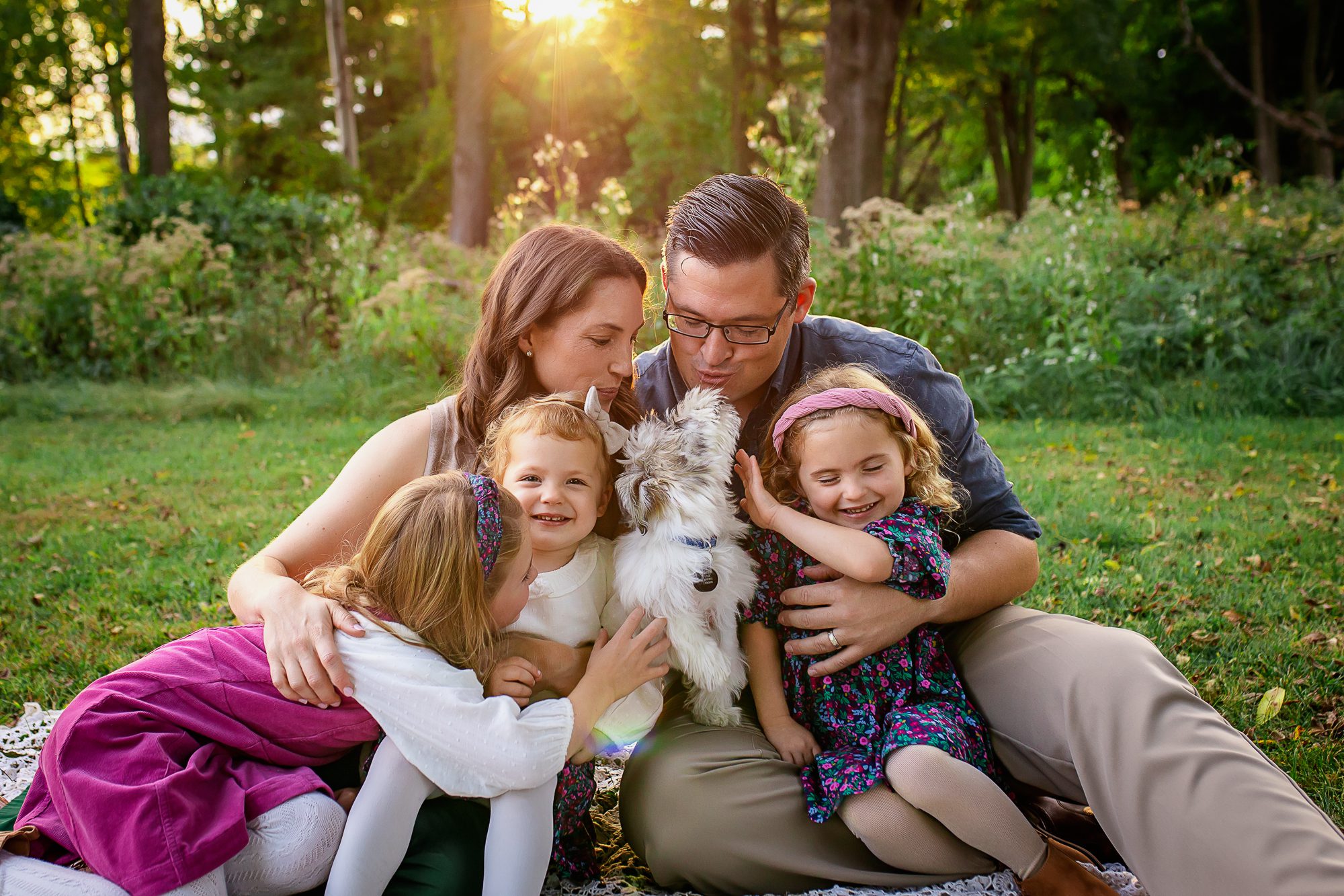 family photographer in rochester ny captures family playing with their dog during fall mini session