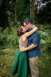 family photographer in rochester ny captures mom and dad kissing during fall mini session