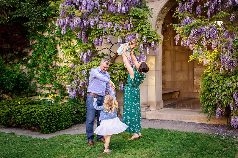 family photographer in rochester ny captures family playing together in the George Eastman Museum gardens