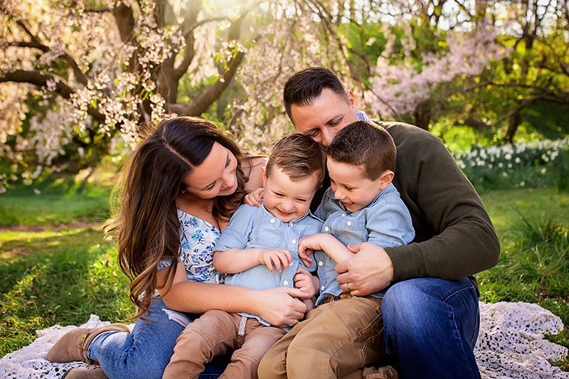 family photographer in rochester ny captures family playing together at Highland Park