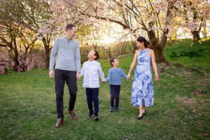 family photographer in rochester ny captures family walking together in the sunset