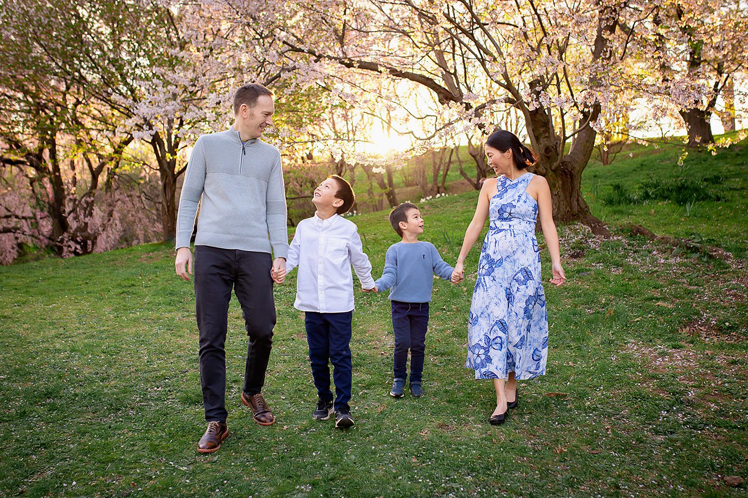 family photographer in rochester ny captures family walking together in the sunset