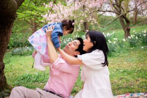family photographer in rochester ny captures parents playing with their daughter