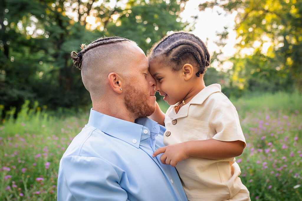 family photographer in rochester ny captures dad and son playing together in the flowers