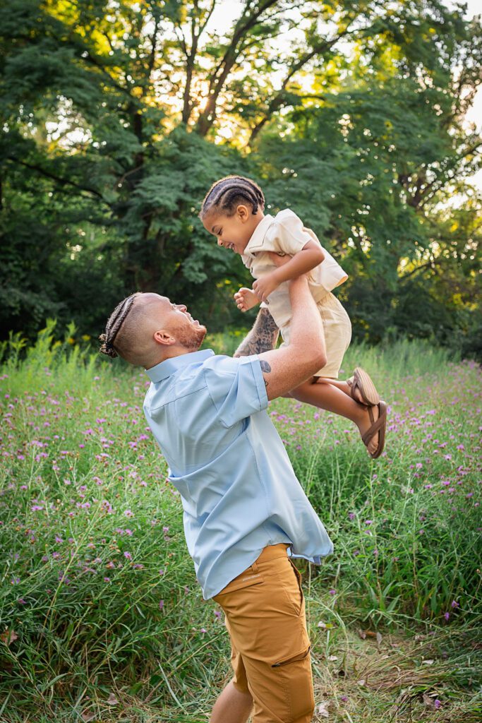 family photographer in rochester ny captures family playing together in the flowers