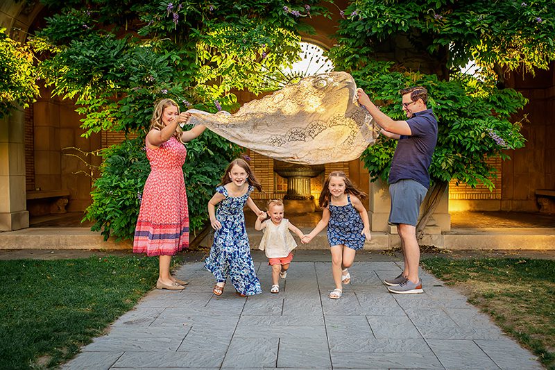 family photographer in rochester ny captures family playing together at the George Eastman Museum